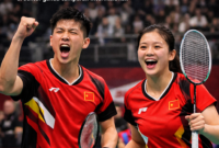 sangan ganda campuran China, Zhu Yiwei dan Bai Xinyi, merayakan poin saat tampil dalam turnamen internasional di bawah naungan Badminton World Federation (BWF).